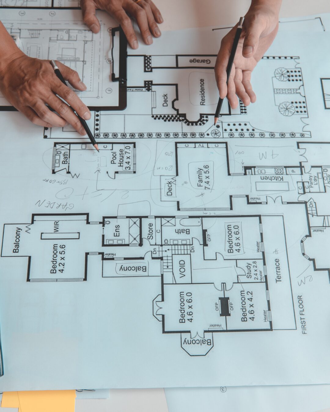 Architect reviewing house plans with pencils