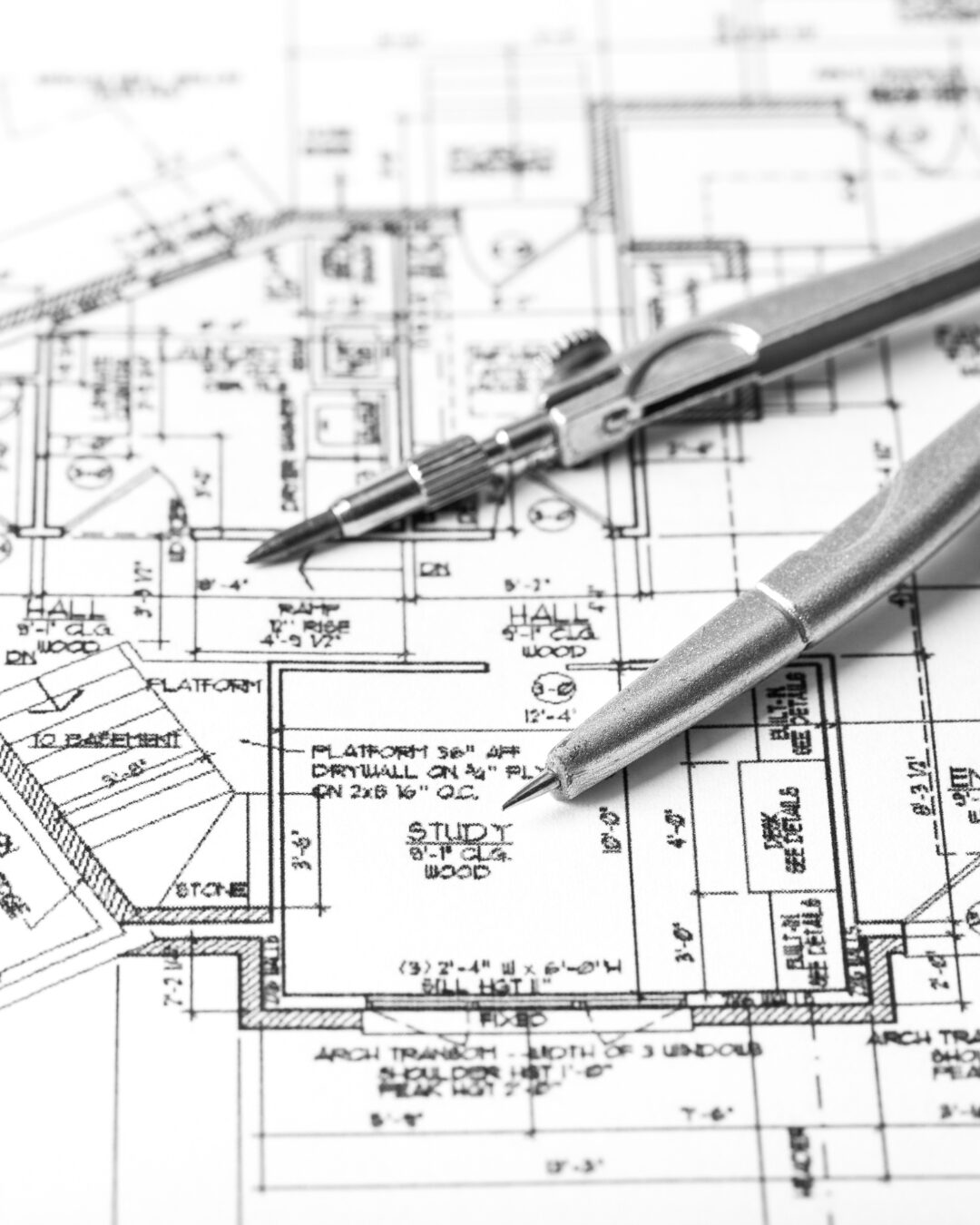 Drawing compass on architectural house plans