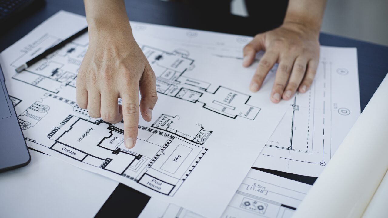 Architect reviewing house plans prepared by A1 Houseplans
