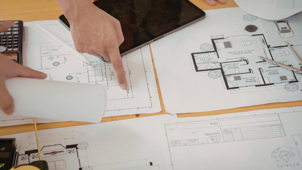 Architects reviewing building plans together